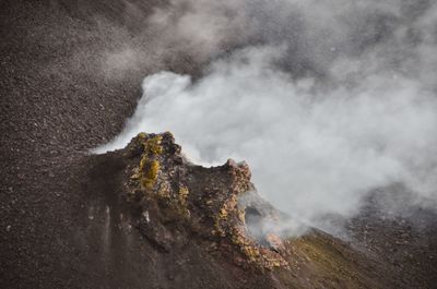 Smoke emitting from volcanic mountain