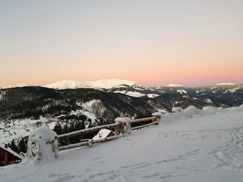 Scenic view of mountains against clear sky during winter