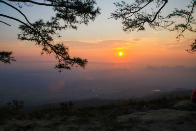 Scenic view of silhouette landscape against orange sky