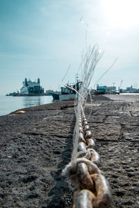 Ship moored at beach against sky