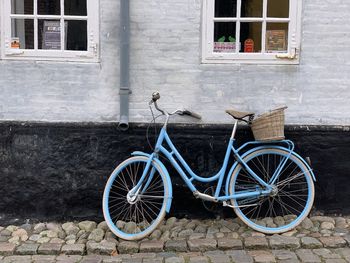Bicycle leaning against brick wall
