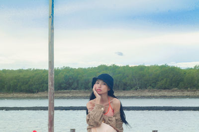 Portrait of beautiful woman against sky