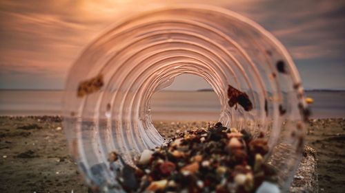 Close-up of water on beach during sunset