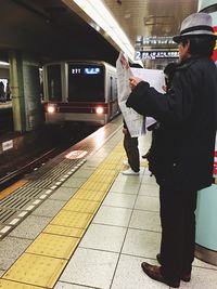 Woman standing on railroad track