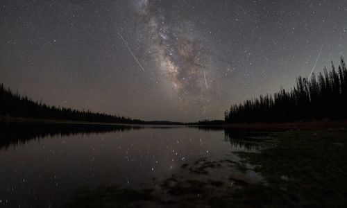 Scenic view of lake against sky at night