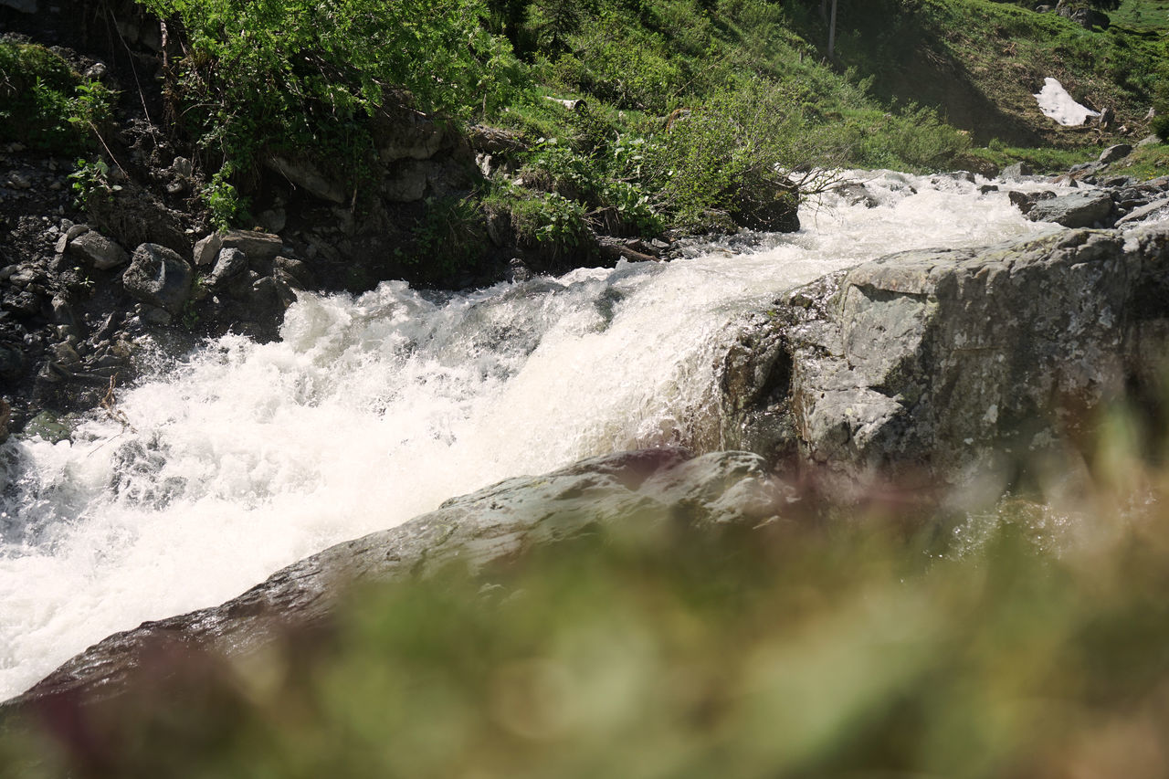 WATER FLOWING THROUGH ROCKS