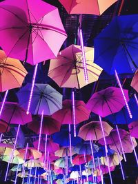 Low angle view of multi colored umbrellas against sky