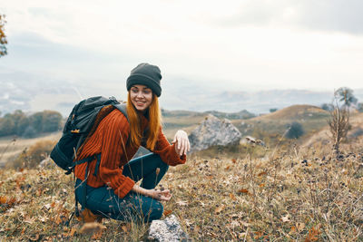 Young woman wearing hat while standing on land