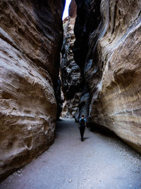 Woman standing in cave at petra entrance