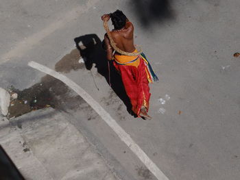 Man with dog walking on road in city