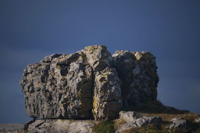 Low angle view of rock formation against blue sky