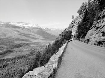 Road amidst mountains against sky