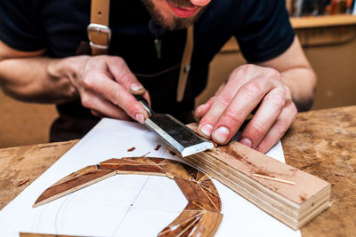 Midsection of man working on table