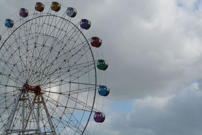 Low angle view of ferris wheel against sky