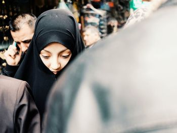 Young woman wearing hijab in city