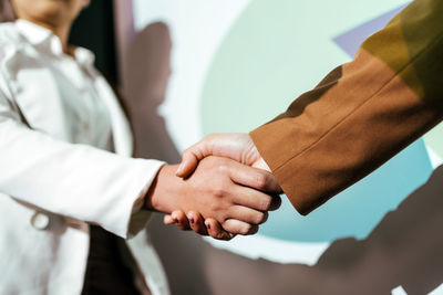 Midsection of doctors stacking hands