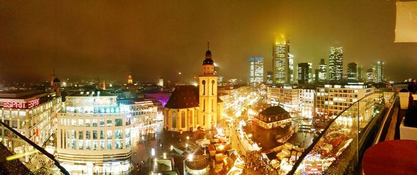 Aerial view of city lit up at night