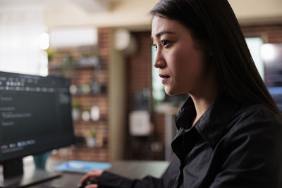 Side view of young woman looking away