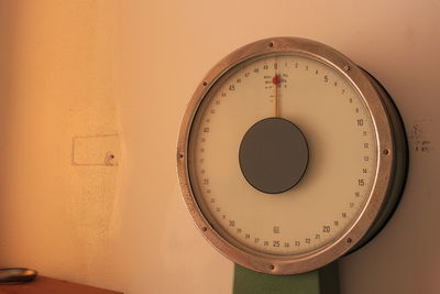 Close-up of clock mounted on wall