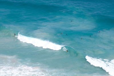 High angle view of surfers in sea