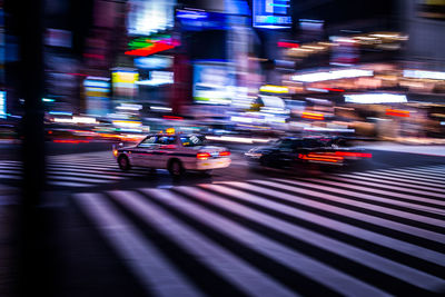 Illuminated city street at night