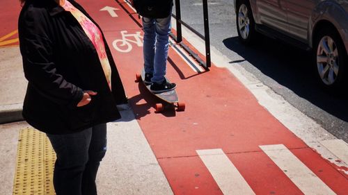 Low section of woman on road