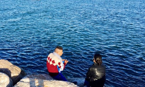 People photographing at sea shore