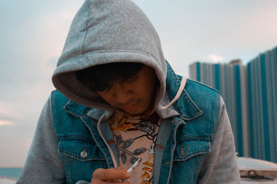 Close-up of young man smoking cigarette