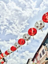 Low angle view of lanterns hanging against sky