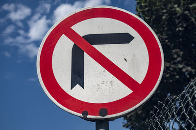 Low angle view of road sign against sky