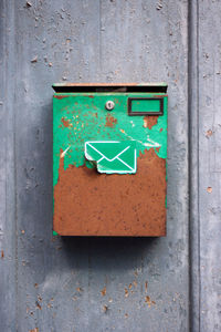 Rusty mailbox on wall