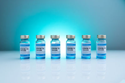 Close-up of bottles against blue background