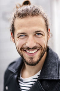 Portrait of a young man with a man bun