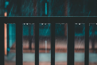 Close-up of wet railing during rainy season