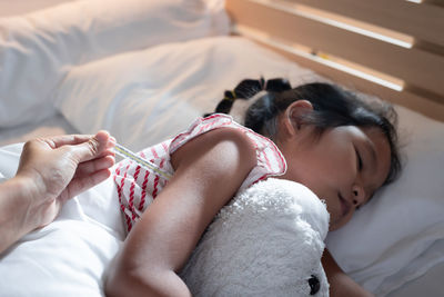 High angle view of woman sleeping on bed at home