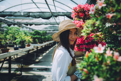 Woman standing by flowering plants