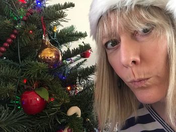 Portrait of woman with christmas tree