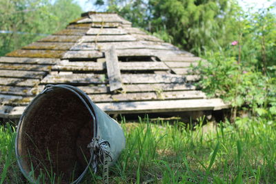 Abandoned wooden structure on field