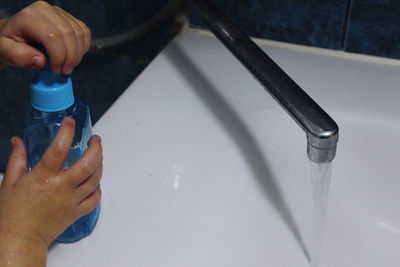 High angle view of person holding bottle