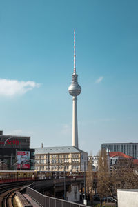 Tower amidst buildings in city against sky