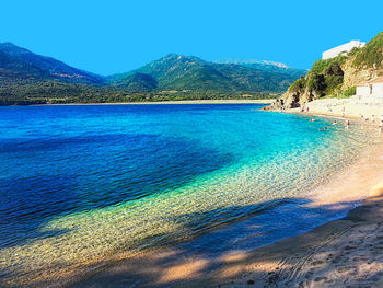 Scenic view of sea against clear blue sky