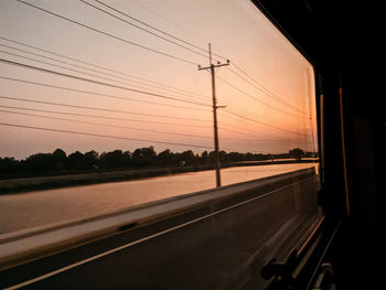 Road against sky seen through car window