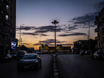 Cars on city street at dusk