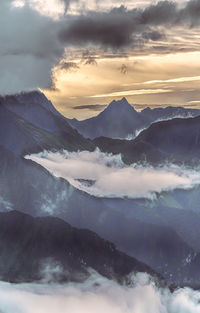 Scenic view of snowcapped mountains against sky during sunset