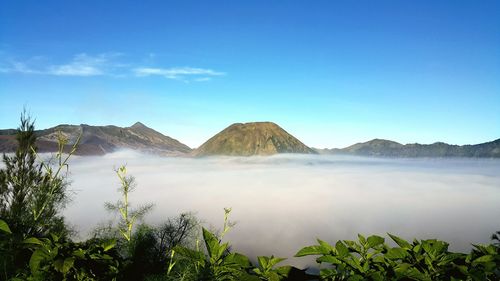 Panoramic view of mountain range against blue sky