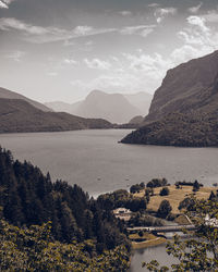 Scenic view of sea and mountains against sky