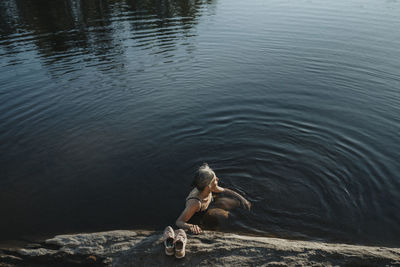 Senior woman swimming in lake
