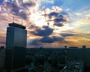 Cityscape against cloudy sky