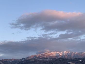 Scenic view of snowcapped mountains against sky during sunset
