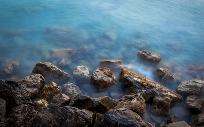 High angle view of rocks in sea